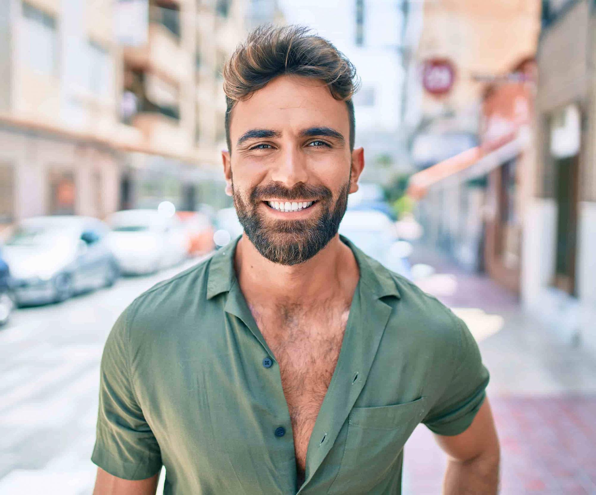 man smiling in city after Gynecomastia